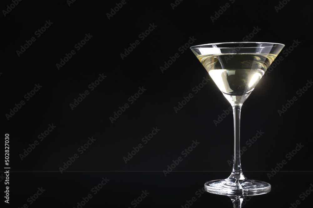 Martini cocktail on dark background. Space for text Martini cocktail on dark background. Space for text