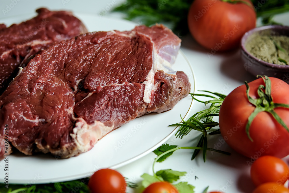 A man cooks a beef steak in a home kitchen. Pepper steak. Raw steak. Raw meat