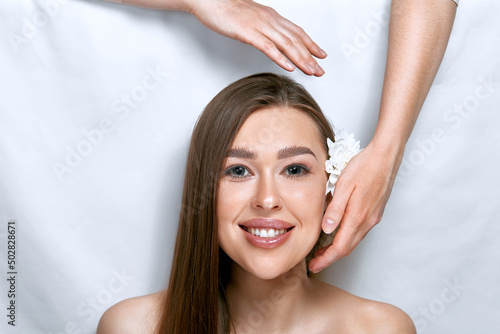 Face massage. Beautiful of young woman getting spa massage treatment at beauty spa salon.Spa skin and body care. Facial beauty treatment.Cosmetology