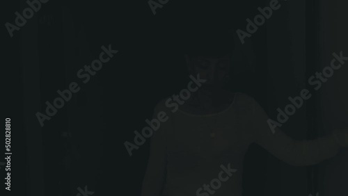 addiction, alcohol -drunk woman gropes along the corridor in the dark photo
