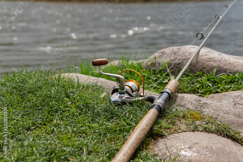 Tableau sur toile Fishing rod near the river ready for fishing