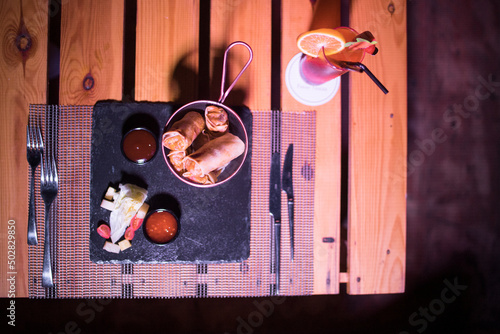 Crispy Briouats on a metallic bowl on the table photo