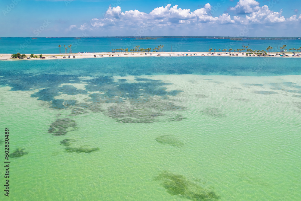 Paradise Summer vacation. Florida beach. Panorama of Dunedin Causeway, Honeymoon Island State Park. Blue-turquoise color of salt water. Ocean or Gulf of Mexico. Tropical Nature. America. Aerial view