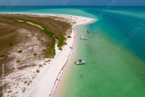 Florida beach. Summer vacation. Panorama of Caladesi island and Honeymoon Island State Park. Blue-turquoise color of salt water. Ocean or Gulf of Mexico. Tropical Nature. North America. Aerial view. 