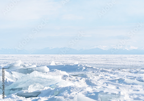 Winter landscape with mountains and Lake Baikal in Siberia at sunset. Natural background.