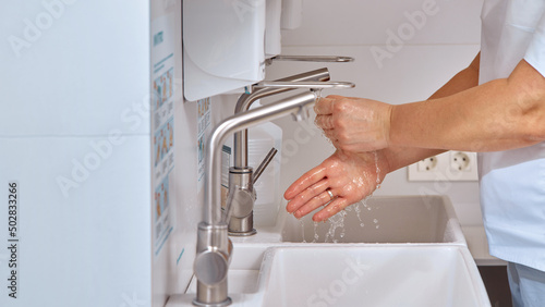 the doctor washes his hands after receiving the patient