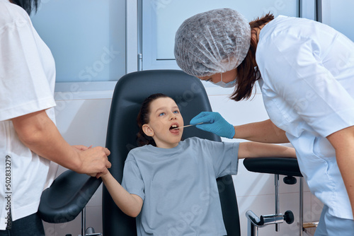 nurse checks little girl s throat