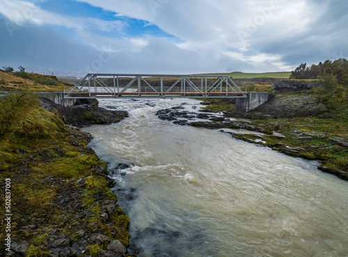 Hrutey island public park near Blonduos town, North-West of Iceland. View during auto trip by Ring Road. Spectacular Icelandic landscape with scenic autumn nature and Blanda river with cataracts. photo