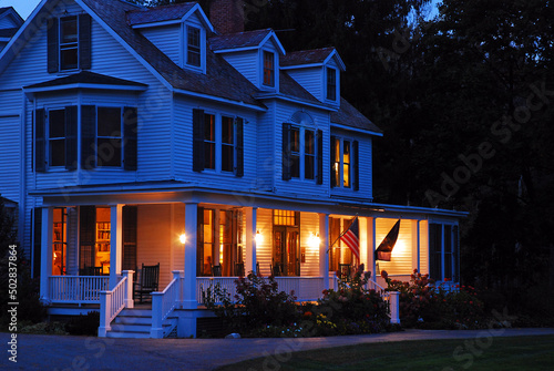 A suburban home is lit at dusk