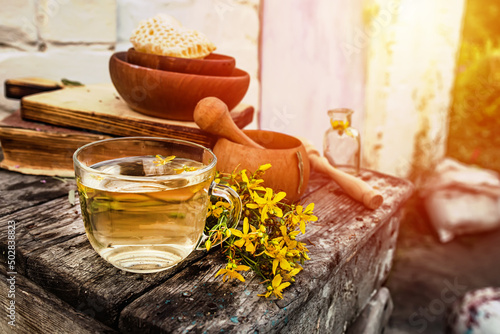 St. John's wort. Hypericum plants yellow flower medicinal tea from dry herbs or a drink from tincture of medicinal plants crushed in a mortar.  photo