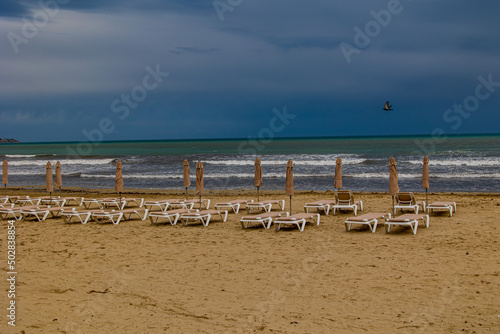 Fototapeta Naklejka Na Ścianę i Meble -   seaside landscape with a beach with sunbeds and the sea in no people