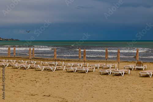  seaside landscape with a beach with sunbeds and the sea in no people
