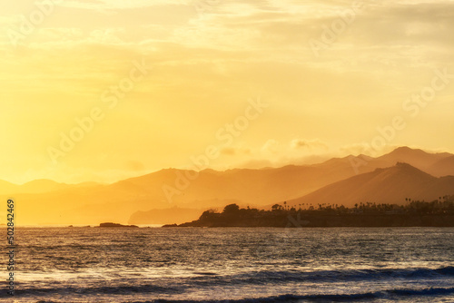 Sunset, sunrise over the ocean, waves, mountains