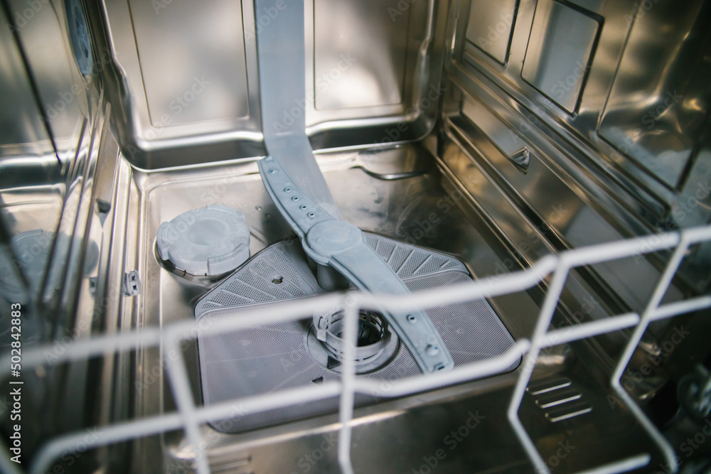 Dishwasher close-up. Modern built-in kitchen appliances. Device, and details. Filter for dishwashers. Dishwasher close-up. Modern built-in kitchen appliances. Device, and details. Filter for dishwashers.