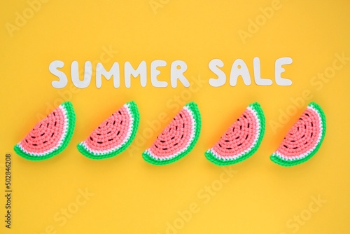 Slices of watermelon and lettering Summer sale on yellow background. Banner with percentage sign. Promotion of the poster sale or percent discount in the store. Mock up, top view, flatlay concept photo