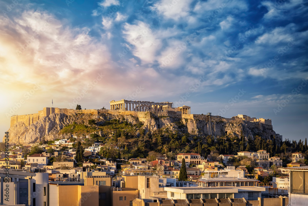 The Parthenon Temple at the Acropolis of Athens, Greece, above the old town Plaka during a golden sunrise
