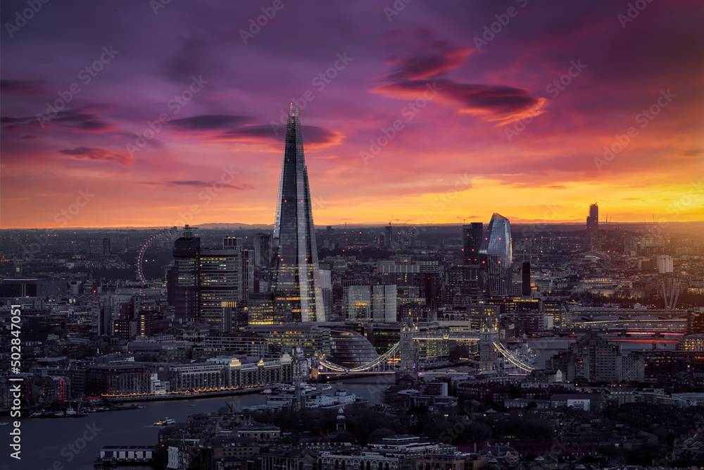 Elevated sunset view to the Tower- and London Bridge district with a colorful sky and soft tones