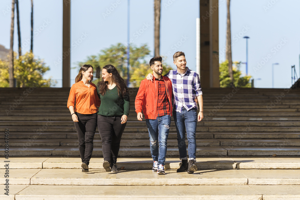Obraz premium a lesbian and a gay couple walk down the steps of a plaza