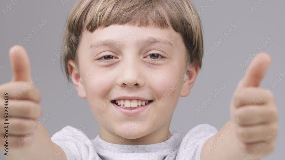 Caucasian boy of 9 years shows smiling the thumbs up Caucasian boy of 9 years shows smiling the thumbs up