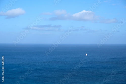 yacht with a white sail in the blue sea off the coast of Malta