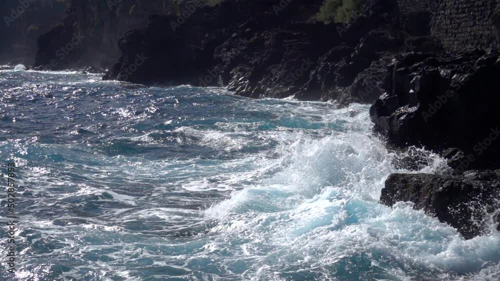 Waves breaking over dark volcanic rocks on La Palma, slow motion Waves breaking over dark volcanic rocks on La Palma, slow motion