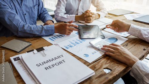 Фотография Team work discussing in valuation data in meeting room, three business people with accounting paper charts