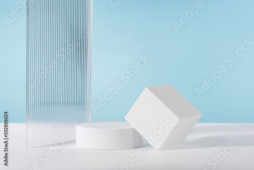 Acrylic ribbed plate  podium  background for cosmetic product packaging on blue backdrop. Showcase for jewellery presentation  display for perfume advertising  cosmetics branding scene mockup