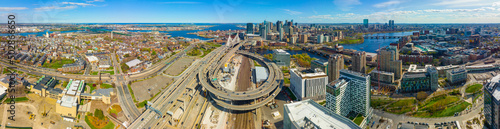 Boston downtown financial district skyline and Leonard Zakim Bridge aerial view, with Boston Harbor and Charles River at the background, Boston, Massachusetts MA, USA.  photo