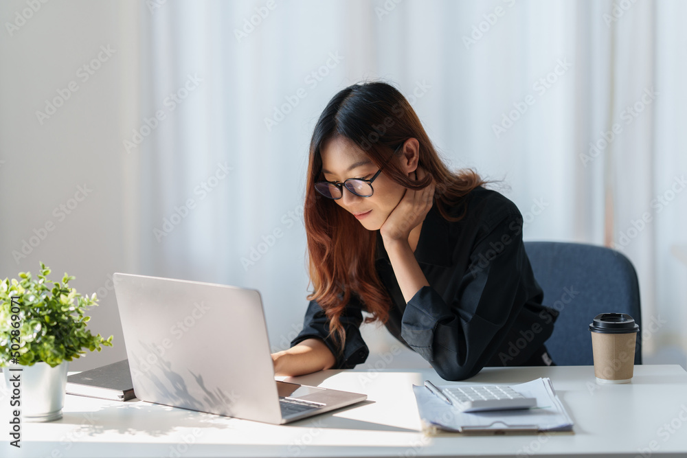 Charming Asian Business Woman working at office. Account and finance concept. Charming Asian Business Woman working at office. Account and finance concept.