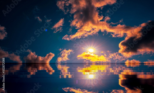 reflection of colorful dramatic sky with clouds, steaming cumulonimbus clouds reflect golden light