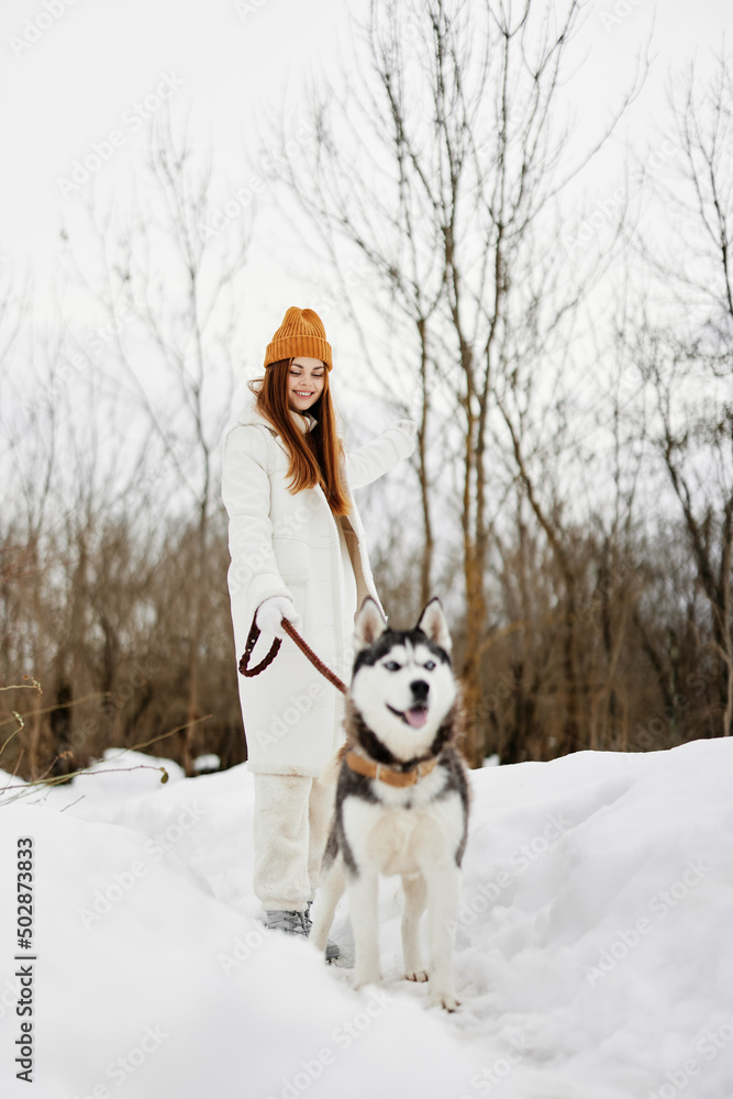 cheerful woman in the snow playing with a dog fun friendship winter holidays