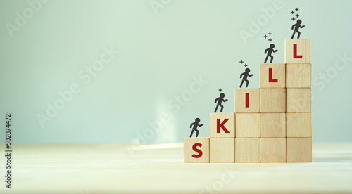 Upskilling and personal development concept. Skill training, education, learning, ability, knowledge and competency  for digital transformantion. Upskilling, reskilling, new skills icon on wooden cube photo