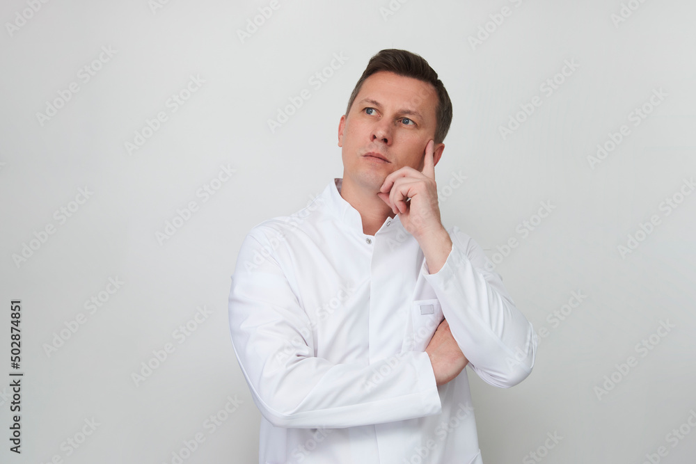Handsome doctor against white background with copy space Handsome doctor against white background with copy space