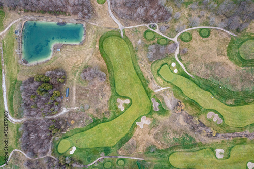 Barrie golf course hills and golf paths on a cloudy day a lot of green and cut grass DRONE VIEW 
