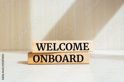 Welcome onboard symbol. Wooden blocks with words 'Welcome onboard'. Business and welcome onboard concept. Copy space.
