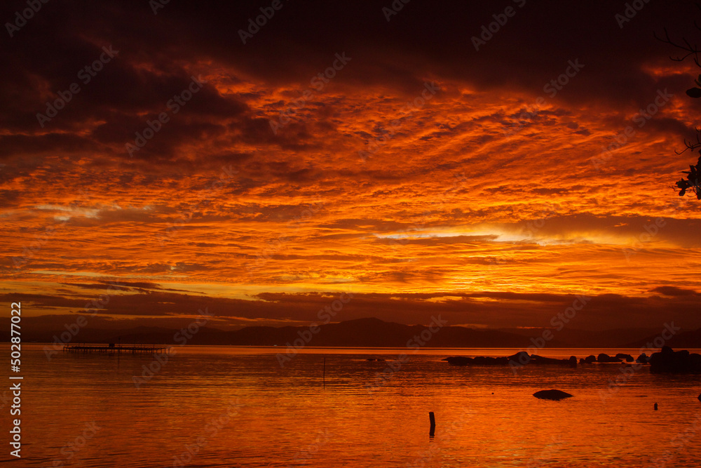 Orangy sunset by the ocean in Florianópolis, Brazi.l Orangy sunset by the ocean in Florianópolis, Brazi.l