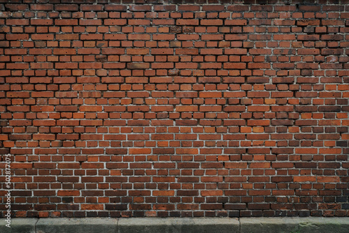 Red big brick wall  surface of stones are rough and cracked   no person