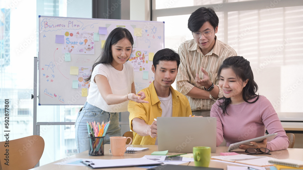 Group of young employees discussing, sharing creative strategies together at modern workplace. Group of young employees discussing, sharing creative strategies together at modern workplace.