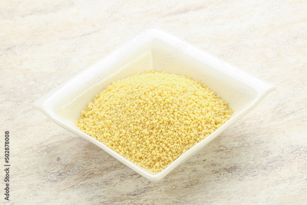 Raw couscous in the bowl Raw couscous in the bowl