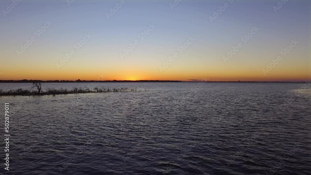 Drone back over a river at sunset. South America. Drone back over a river at sunset. South America.