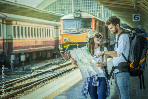 Multiethnic Travellers are looking at the map at the train station, Travel and transportation concept