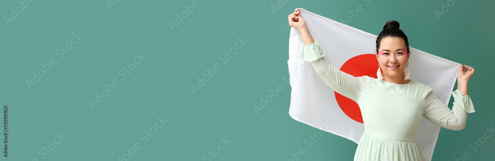 Beautiful young Asian woman holding flag of Japan on green background with space for text Beautiful young Asian woman holding flag of Japan on green background with space for text