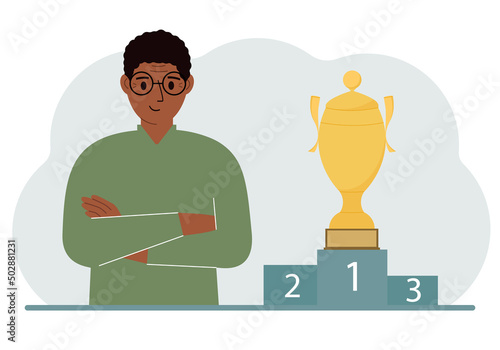 A man next to the pedestal on which the cup for victory and first place.