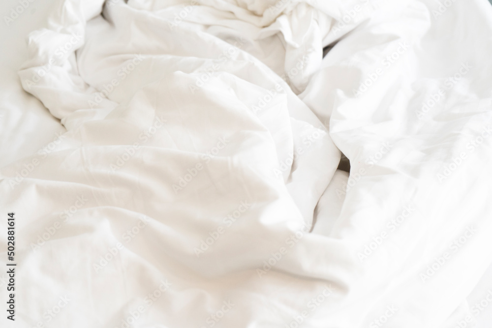 after waking up in the morning. The crinkle blanket on the bed in the hotel with the sunlight on the blanket after waking up in the morning. The crinkle blanket on the bed in the hotel with the sunlight on the blanket