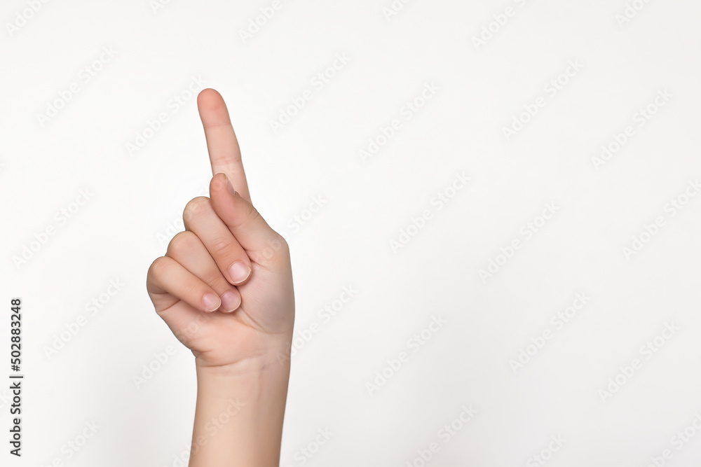 a child hand showing a sign on a white background. isolate.