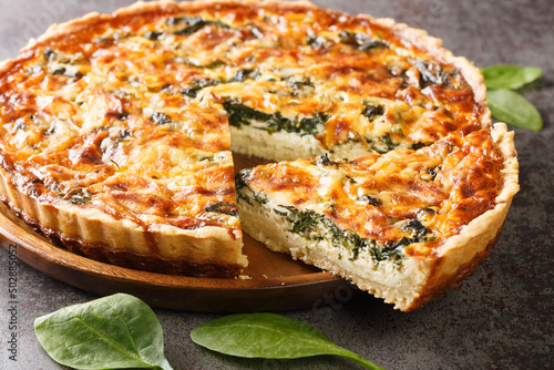 Leinwand Poster Quiche Florentine is a fresh spinach quiche baked in a homemade pie crust to serve for brunch or breakfast for dinner on gray table close-up