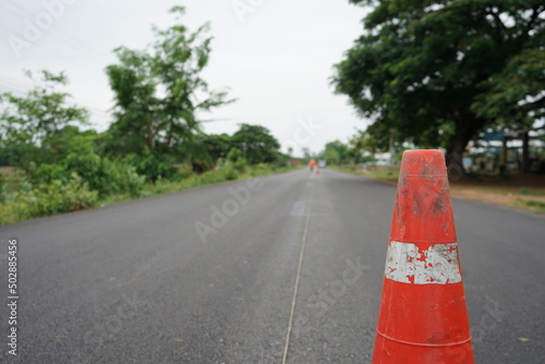 Blurred image of yellow traffic marking work on paved road © suwichan