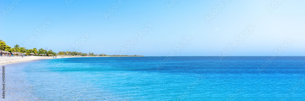 Panorama of a tropical beach and a blue ocean on a sunny summer day