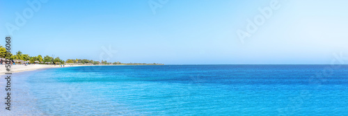 Panorama of a tropical beach and a blue ocean on a sunny summer day © DZiegler