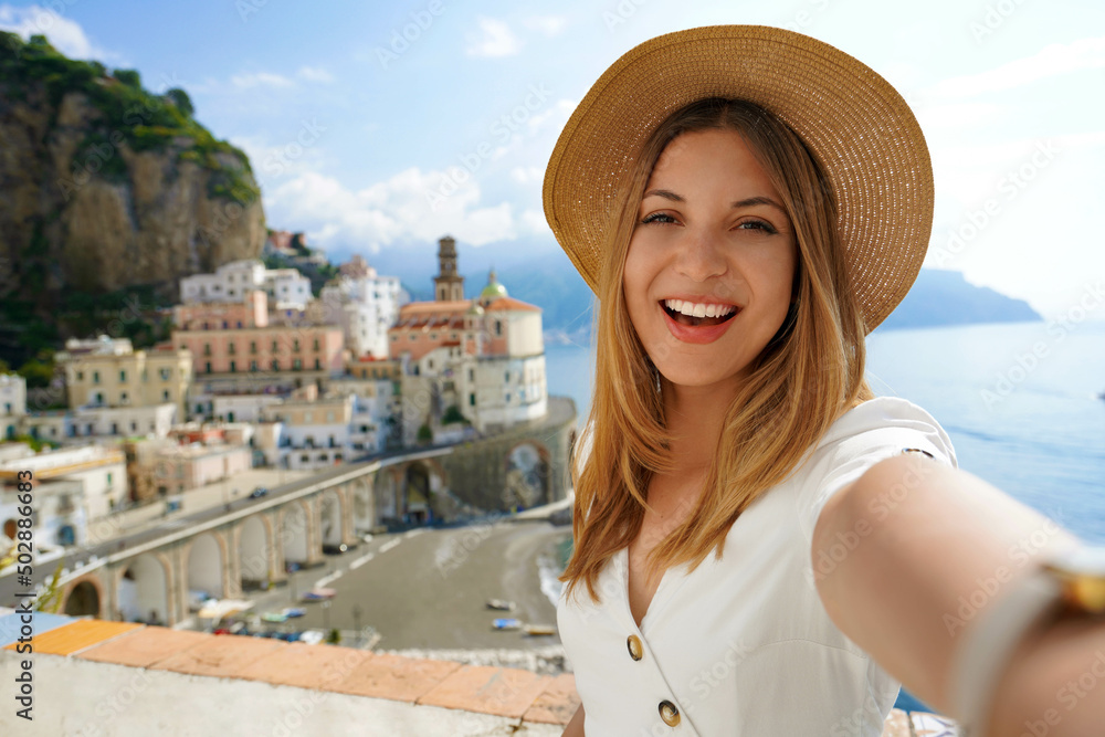 Travel in Europe. Selfie woman on Amalfi Coast, Italy. Happy laughing tourist girl taking self-portrait picture with smartphone during summer vacation in famous European destination, Italy.